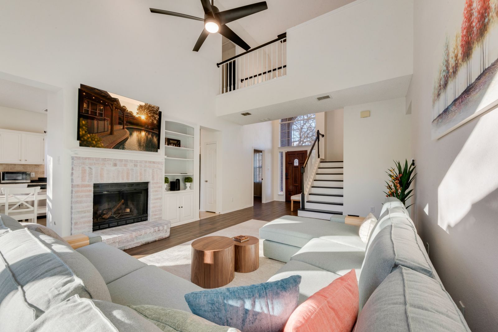 Two-story living room with the staircase